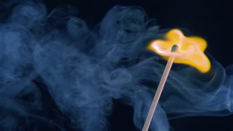 burning match on a black background in slow motion