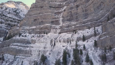 Aerial-view-of-a-frozen-waterfall-along-a-shear-cliff-in-the-Rocky-Mountains