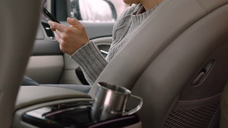 Woman-Using-Mobile-Phone-While-Sitting-On-Car-Passenger-Seat