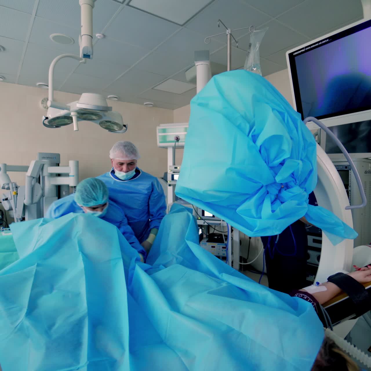 In surgery. Medical team performing operation in hospital operating theater. Working with surgical instruments.
