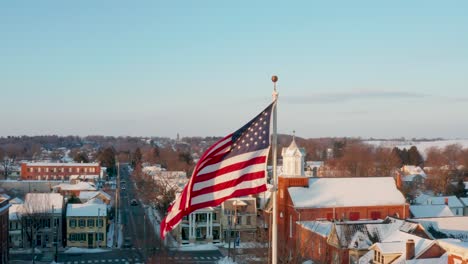 aerial of american flag in winter snow