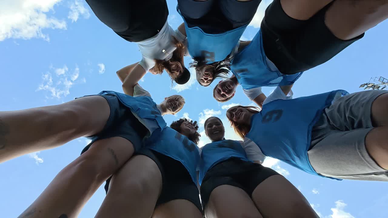 Team of athletes in a huddle