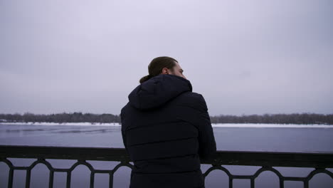 long-haired guy outdoors in a cold day