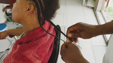 african man making braids