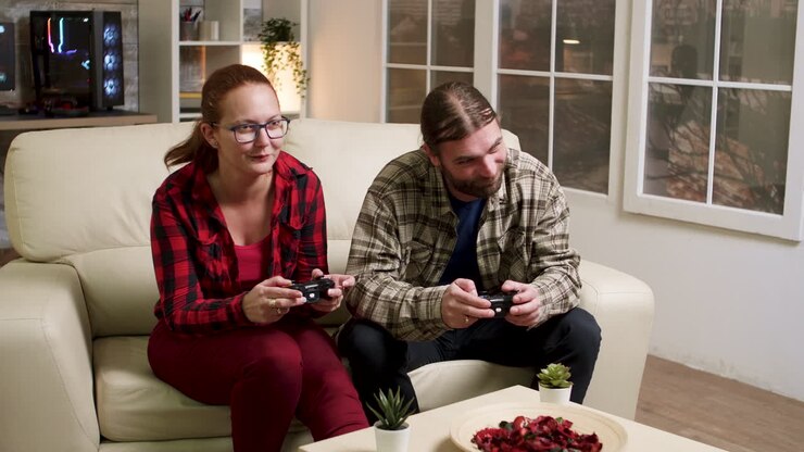 Couple playing video games on couch