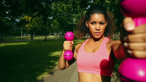 slender woman using dumbbells