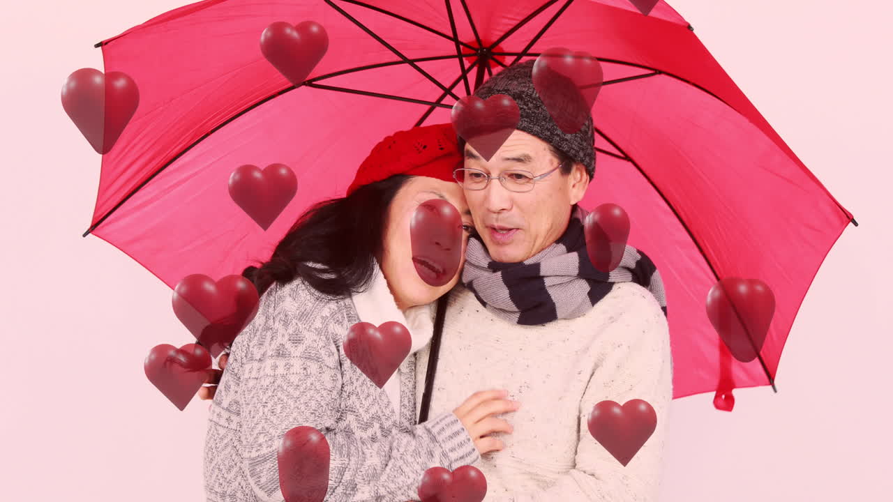 분홍색 우산과 함께 사랑에 빠진 커플 위에 빨간 심장의 애니메이션