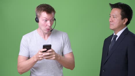mature japanese businessman and young scandinavian man worker together
