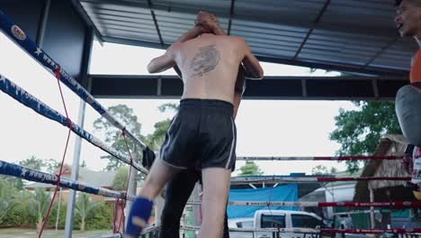 muay thai fighters training in a boxing ring