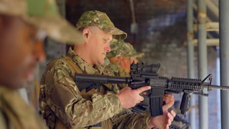 Side-view-of-mixed-race-military-soldiers-loading-weapon-during-training-4k