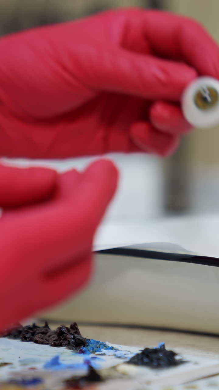 Synthetic eye in doctor's hands. Medical specialist in red latex gloves holding artificial eye prosthesis. Close-up. Ophthalmology concept. Vertical video