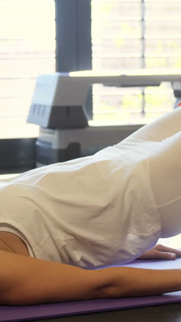 physiotherapist assisting a patient with exercise ball