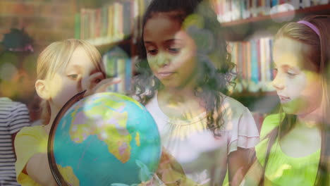 animation of leaves over diverse schoolchildren looking at globe