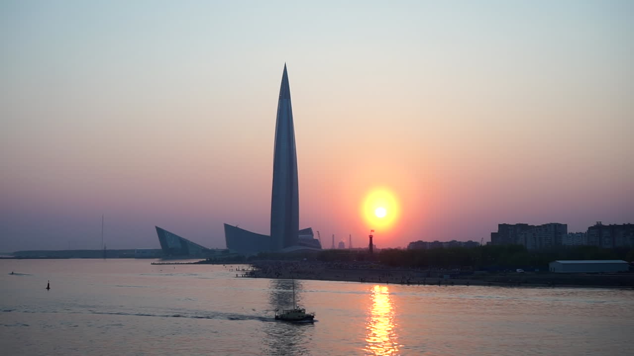 Sunset over the city with a skyscraper and a river