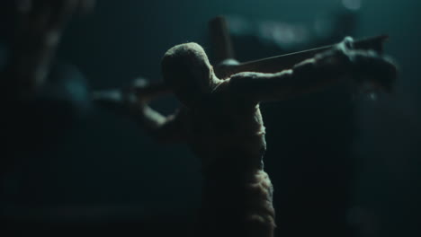 a miniature mummified doll hanging on the gallows at night