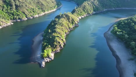 aerial view of a winding river through lush green landscape