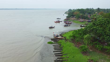 fishing boats moored on a riverbank in a rural village