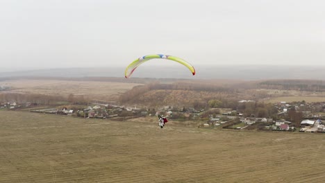 paragliding over a rural landscape