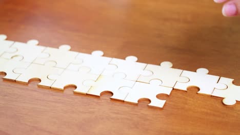 a close-up view of hands piecing together a puzzle illustrating focus and cognitive engagement