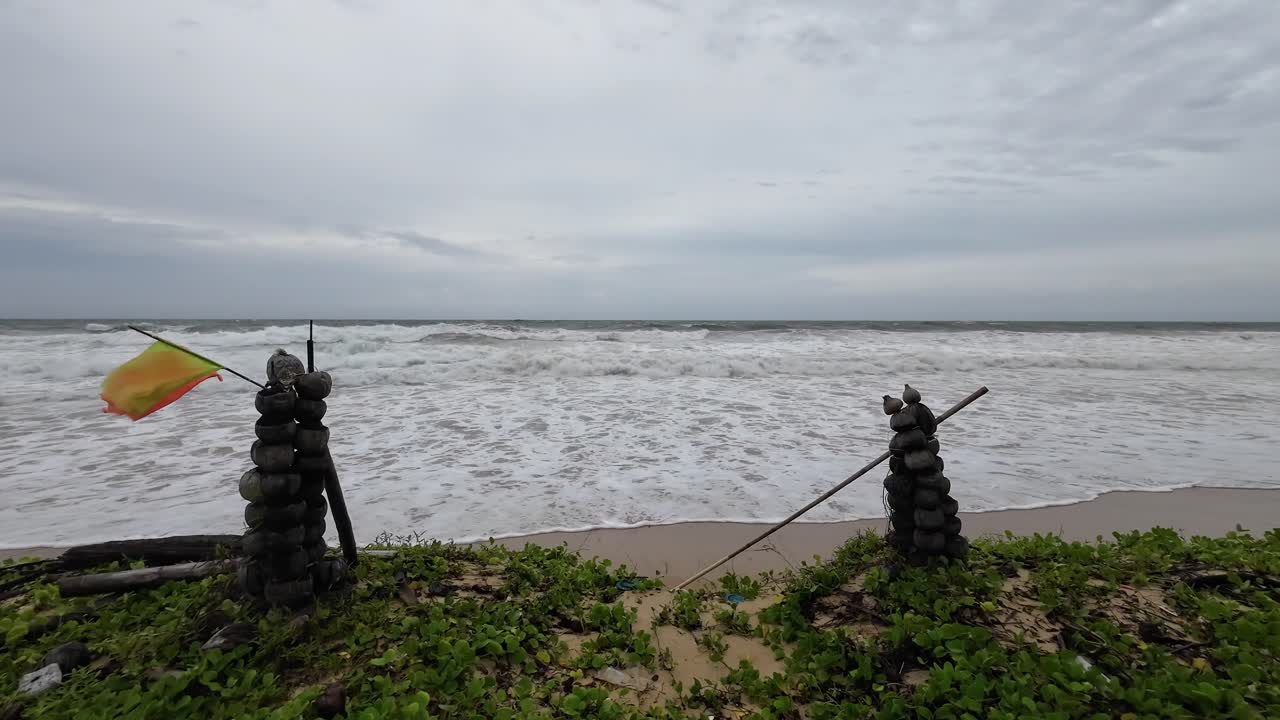 Big waves behind coconut gate at Karon Beach in Phuket Thailand. No Swimming Raining Season
