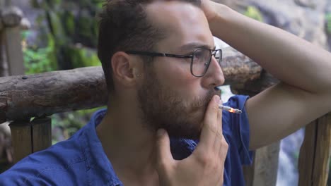 young man smoking in the city.