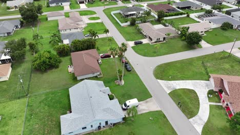 aerial establishing shot of noble villas and mansions with large yard and palm trees