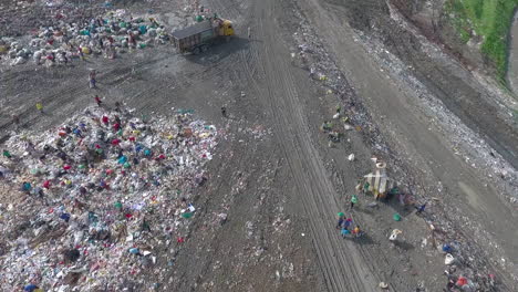 aerial shot of garbage and scavengers looking for recyclable items in payatas landfill