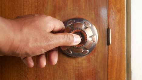 hand turning a door knob