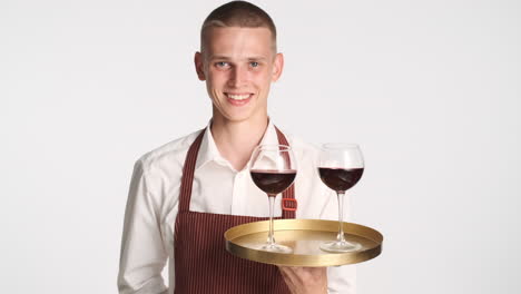 waiter holding two glasses of wine on a tray