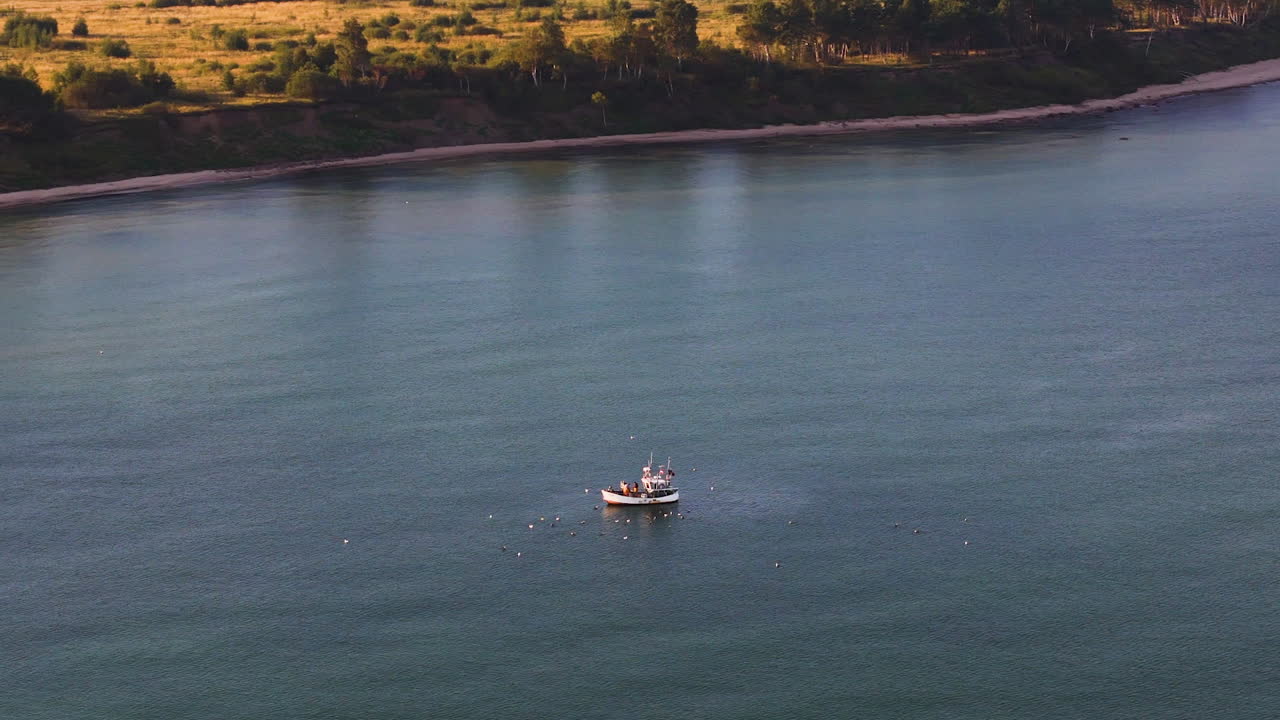 Lonely fishing boat in middle of lake, aerial drone view