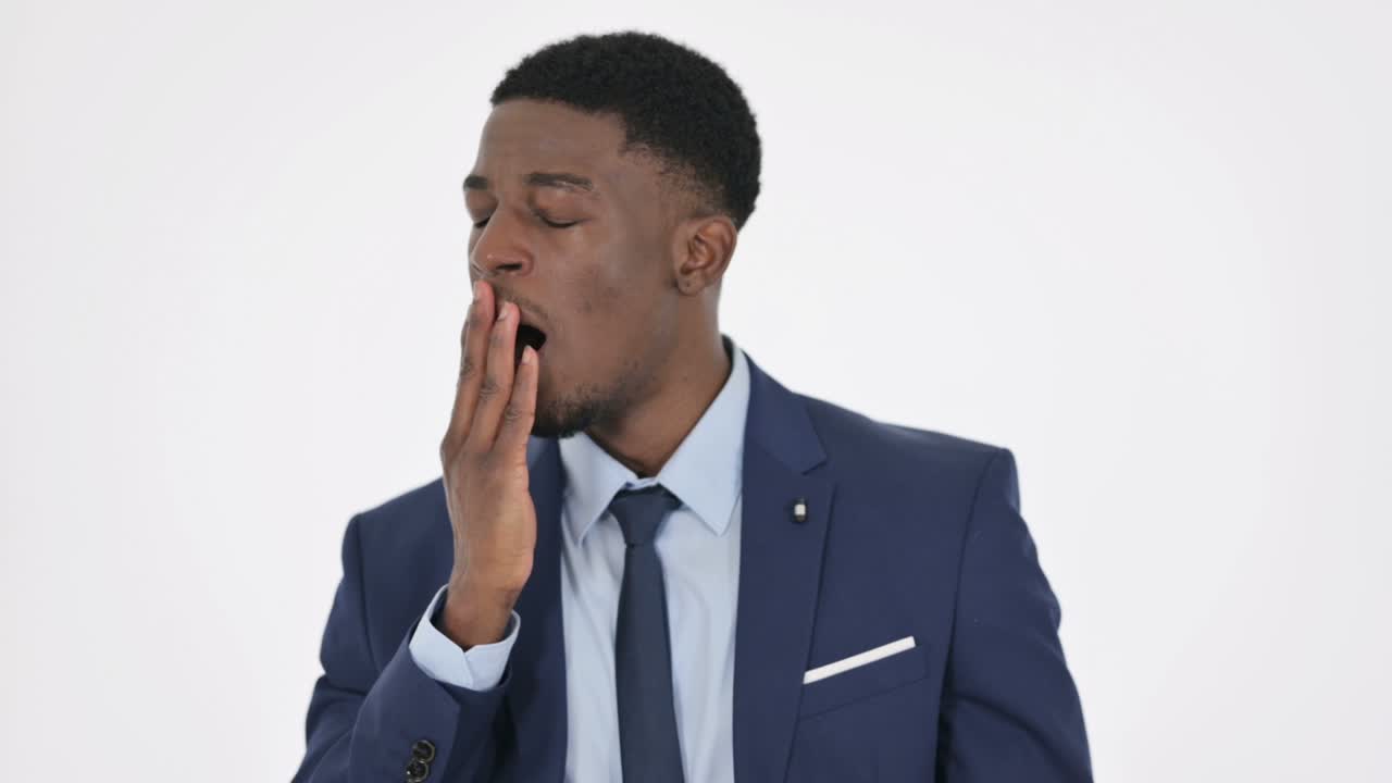 African Businessman Yawning on White Background