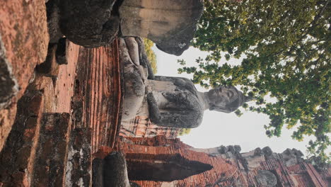 vertical-of-ancient-buddha-sculpture-in-thai-forest