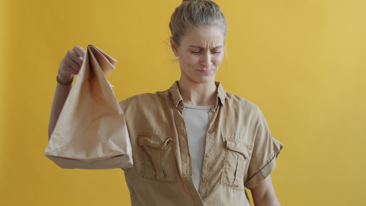 Woman comparing paper and plastic bags