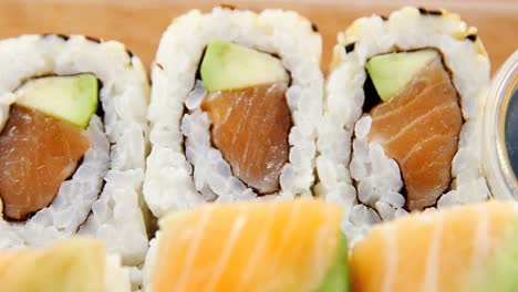 sushi rolls with salmon in plastic container