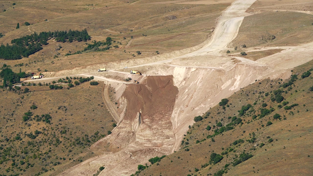 Aerial View of Heavy Machinery Working at a Large Construction Site