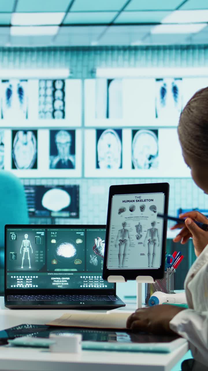 Medical Professional Studying Human Skeleton on Digital Tablet and Laptop