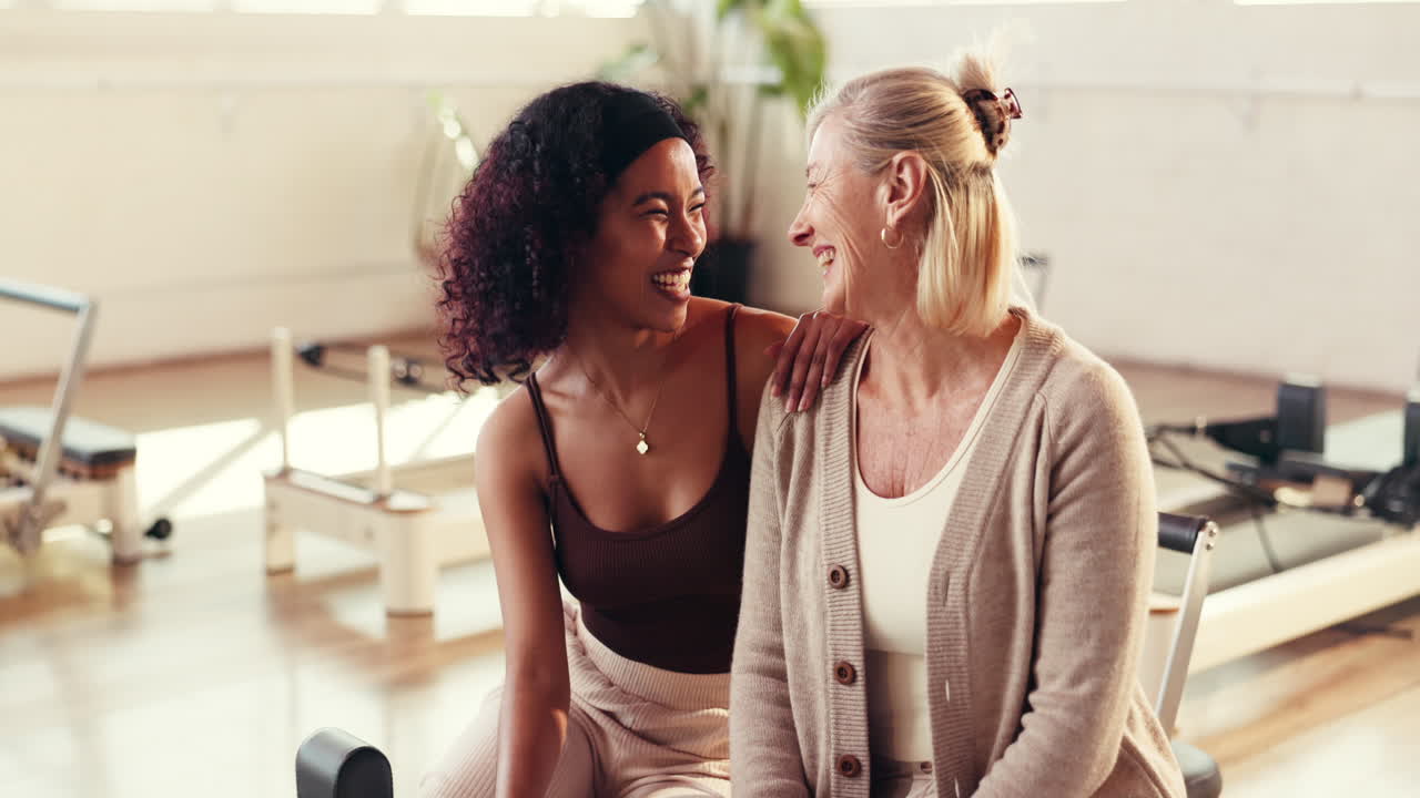 Two Smiling Women in Pilates Studio