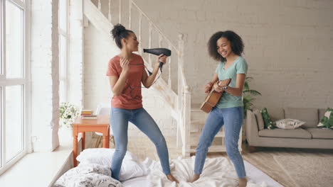 friends singing and dancing on bed