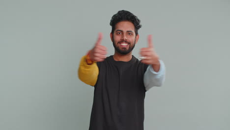 Indian-young-man-raises-thumbs-up-agrees-or-gives-positive-reply-recommends-advertisement-likes-good