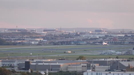 airplane descent on an international airport landing on the runway, wide shot, transport concept