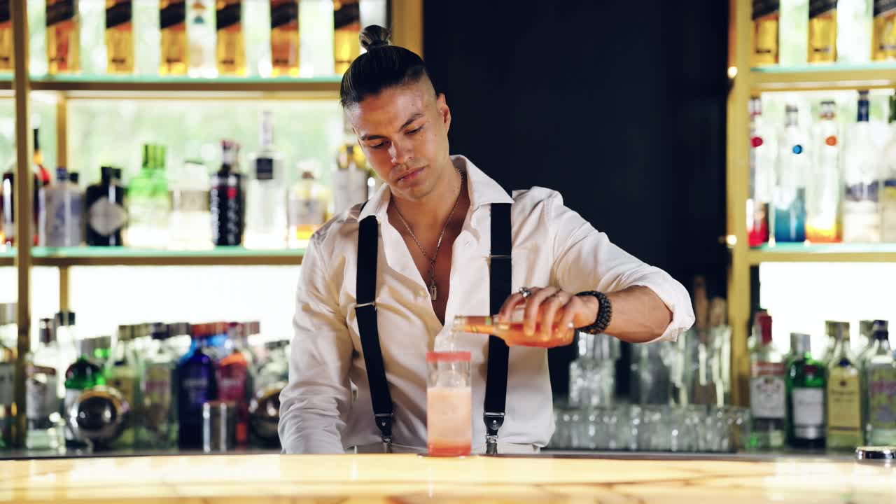 Professional Bartender Preparing a Cocktail at a Modern Bar