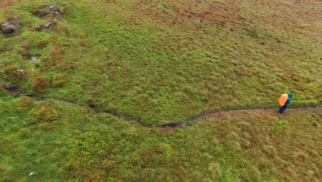 Top-view-of-backpacker-exploring-an-walking-towards-Five-Stones-in-England