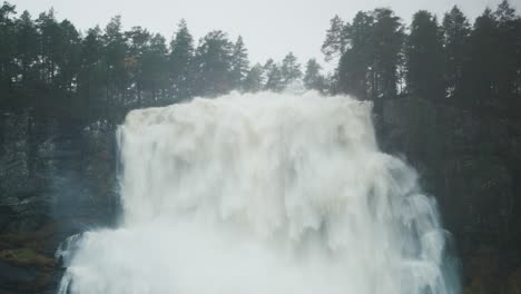 a raging overflowing tvindefossen waterfall after the heavy rain