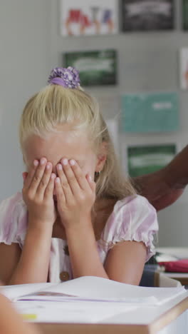 video of african american male teacher supporting sad caucasian girl