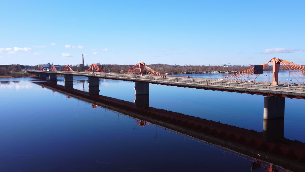 Aerial establisher shot of Southern Bridge in Riga on a calm sunny day, forward