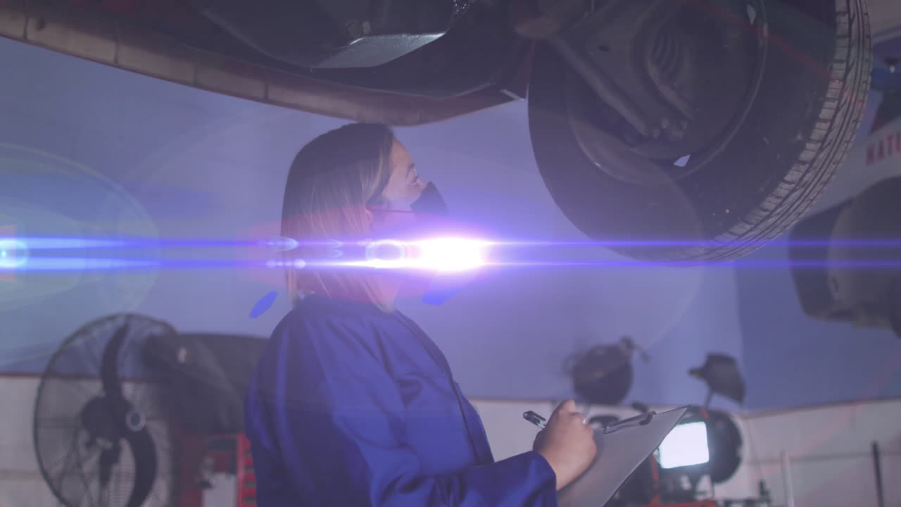 Female mechanic shining torch under car in auto shop, showing animated brake overlay