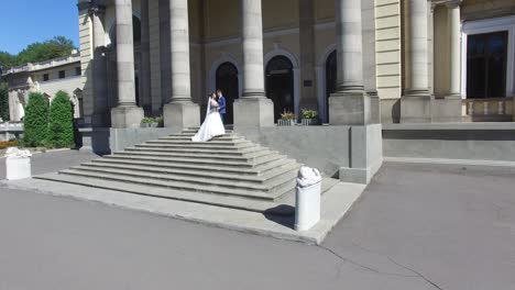 wedding day. wedding session. aerial shot of a happy wedding couple hugs each other before old building