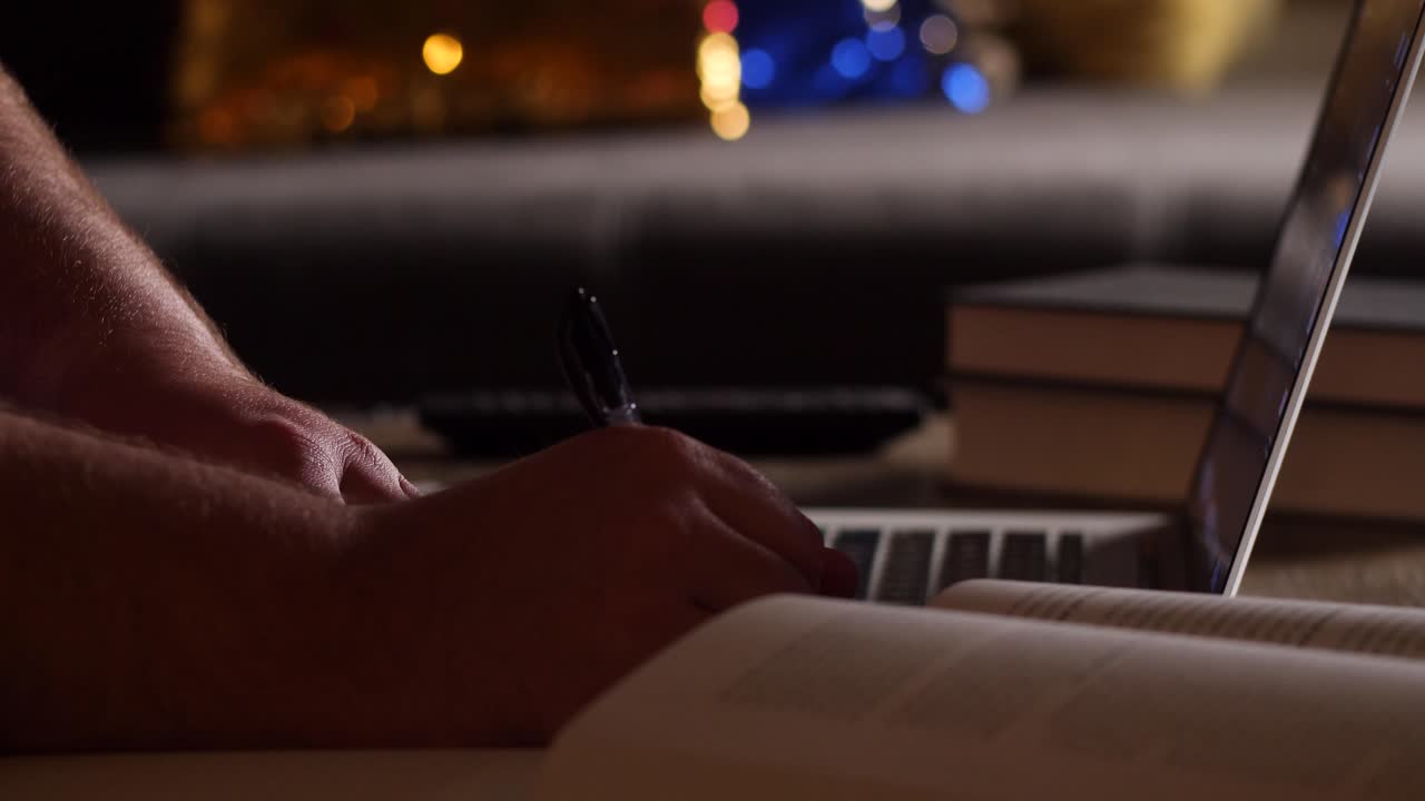 Caucasian Man Studies From Home with Laptop and Notebook on Coffee Table