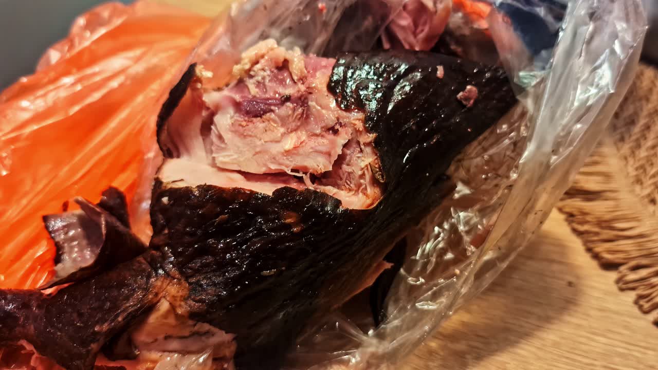 Smoked meat on orange bag, rustic cooking, intense flavor focus