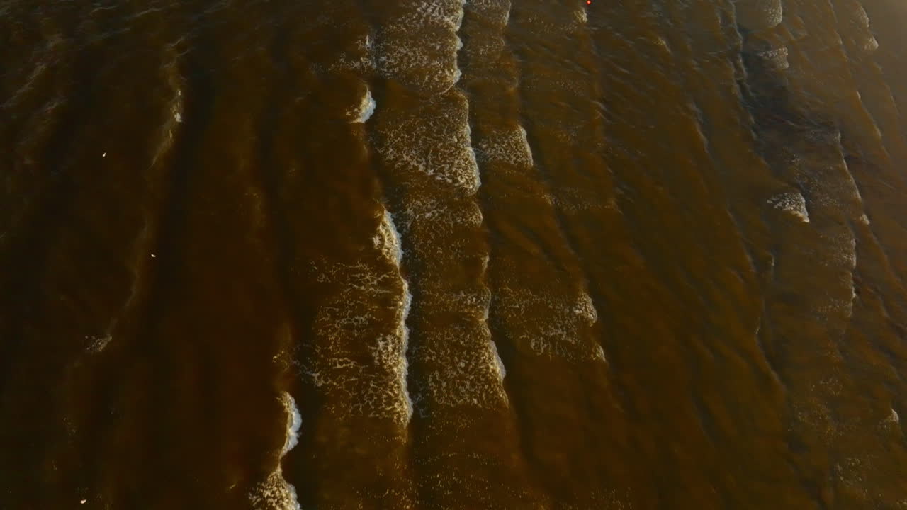 Aerial tilt reveal of the Jūrmala beach, sunny, summer evening in Latvia
